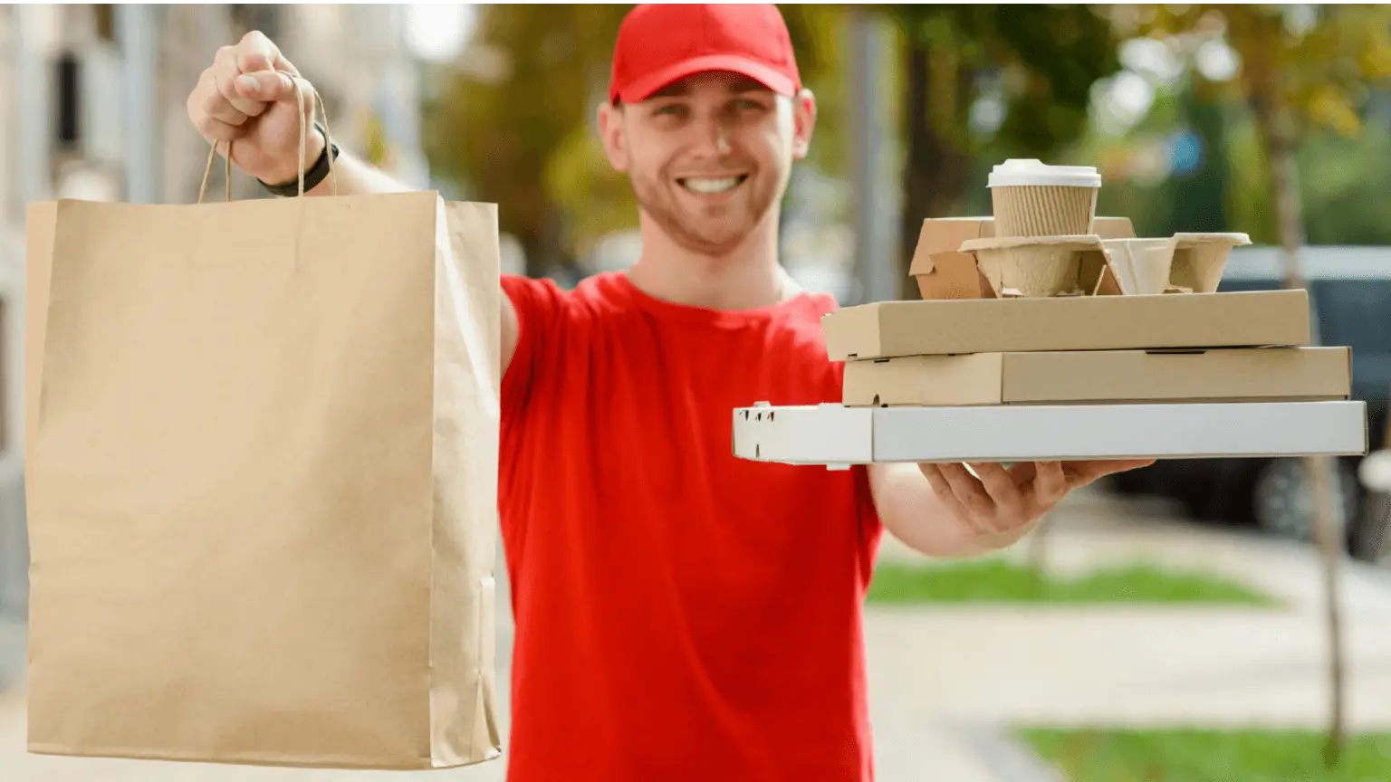 Image: Shutterstock Food delivery man with paper bag and boxes