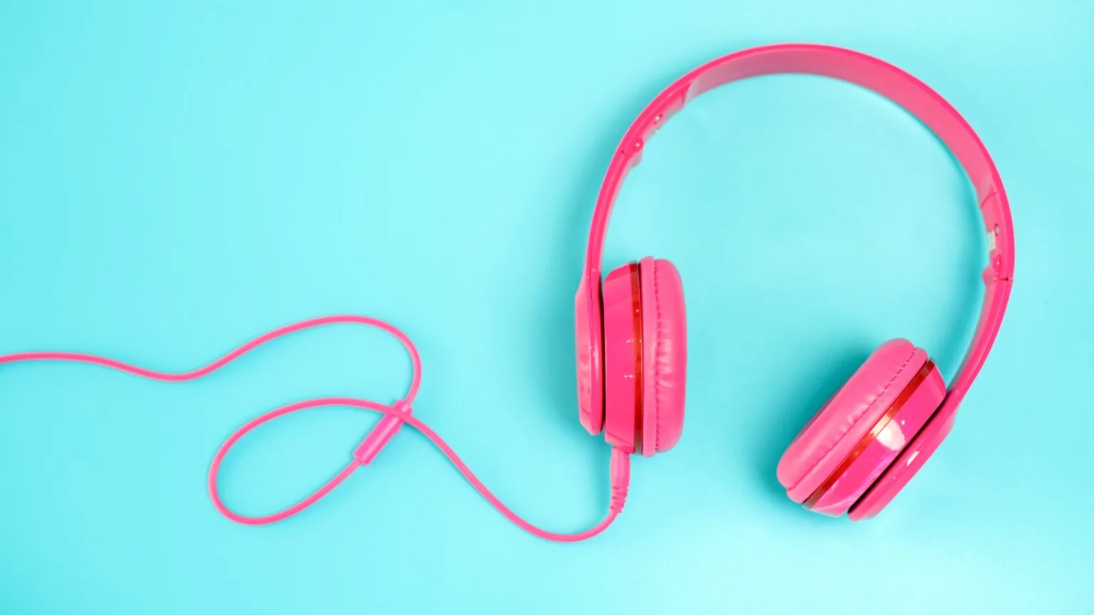 Image: Getty Images Pink headphone on light with blue background