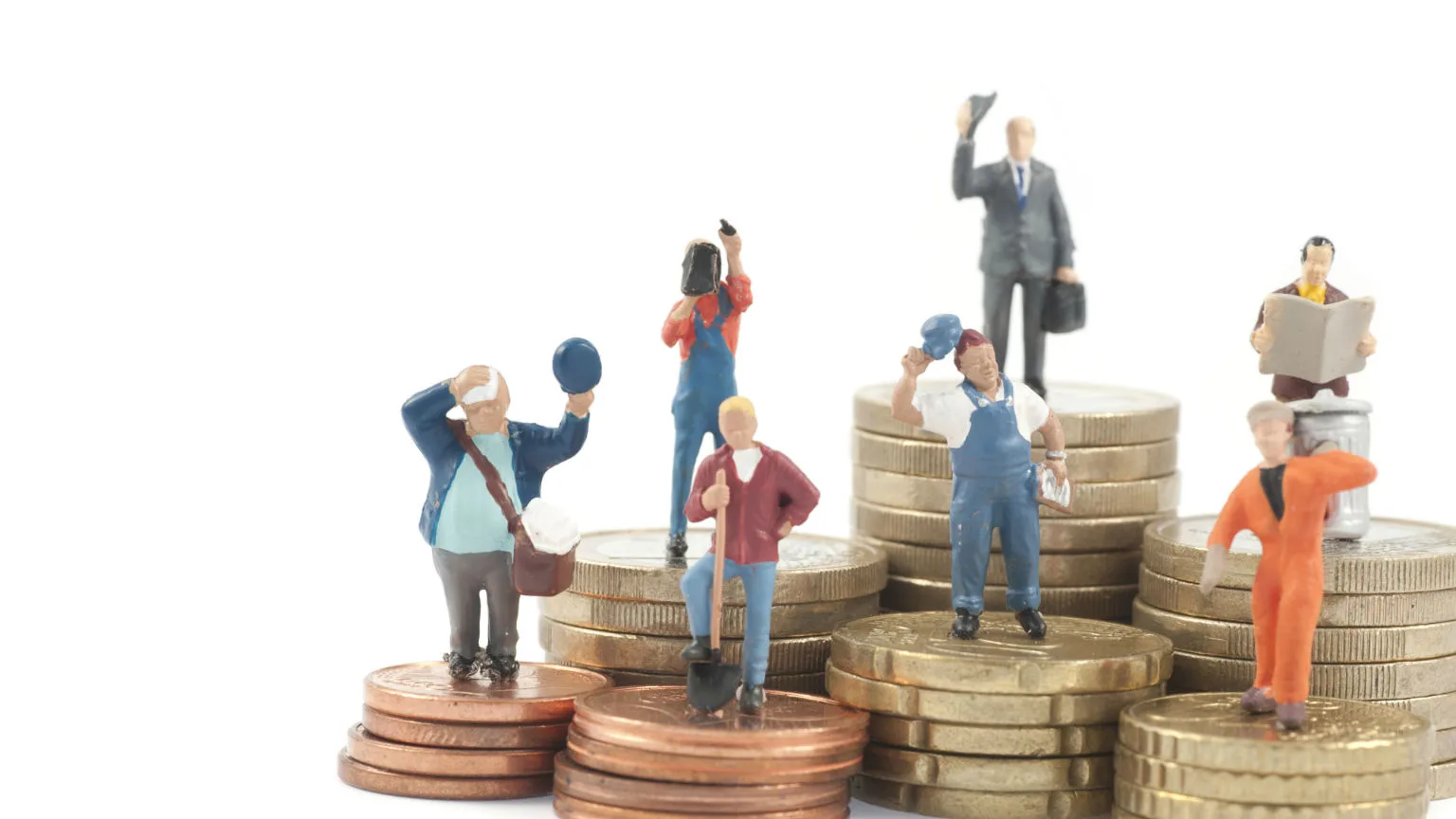 Image: Getty Images Worker figurines standing on coins.
