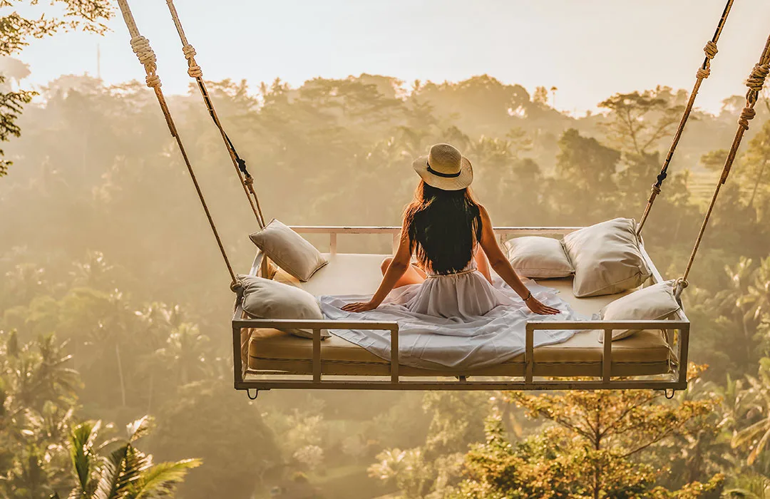 Image: Getty Images Woman Swinging On A Bed In A Forest