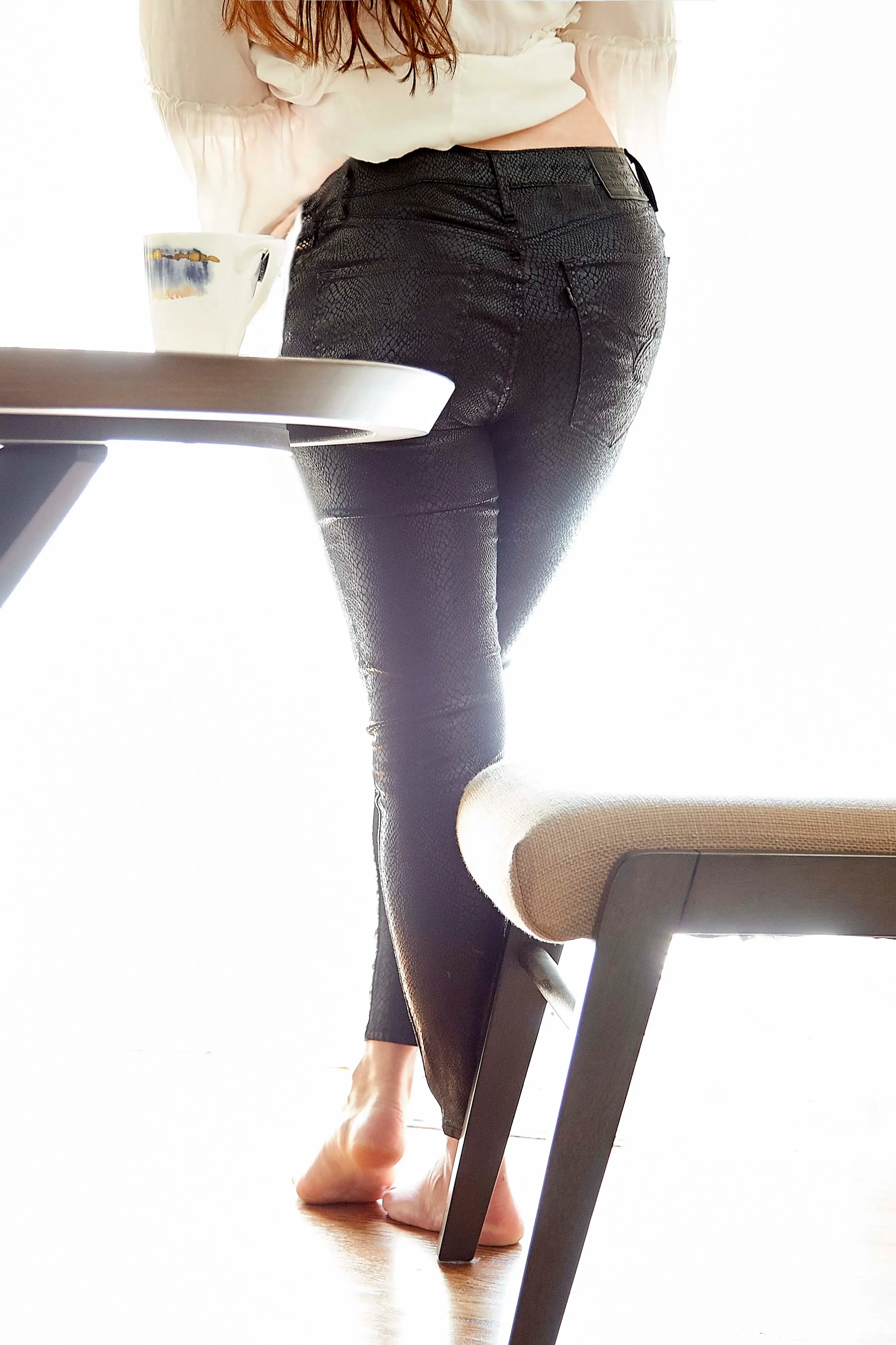 Image: Matt Wagemann/Finder Back view of woman wearing Levi's black snake foil print jeans