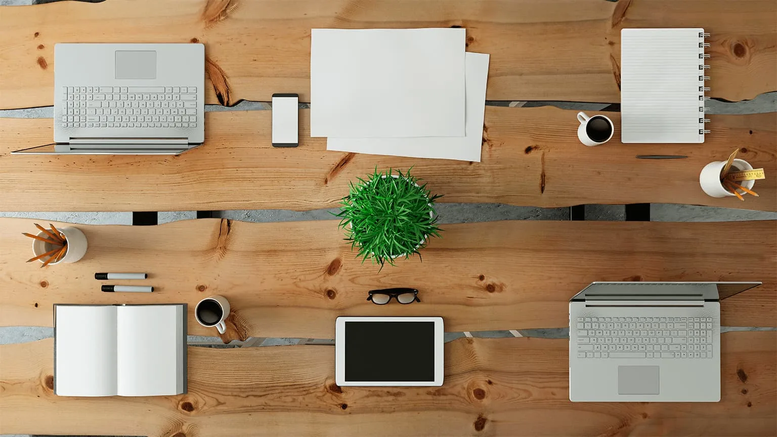 Image: Getty Images Top View of a desktop where a team is working