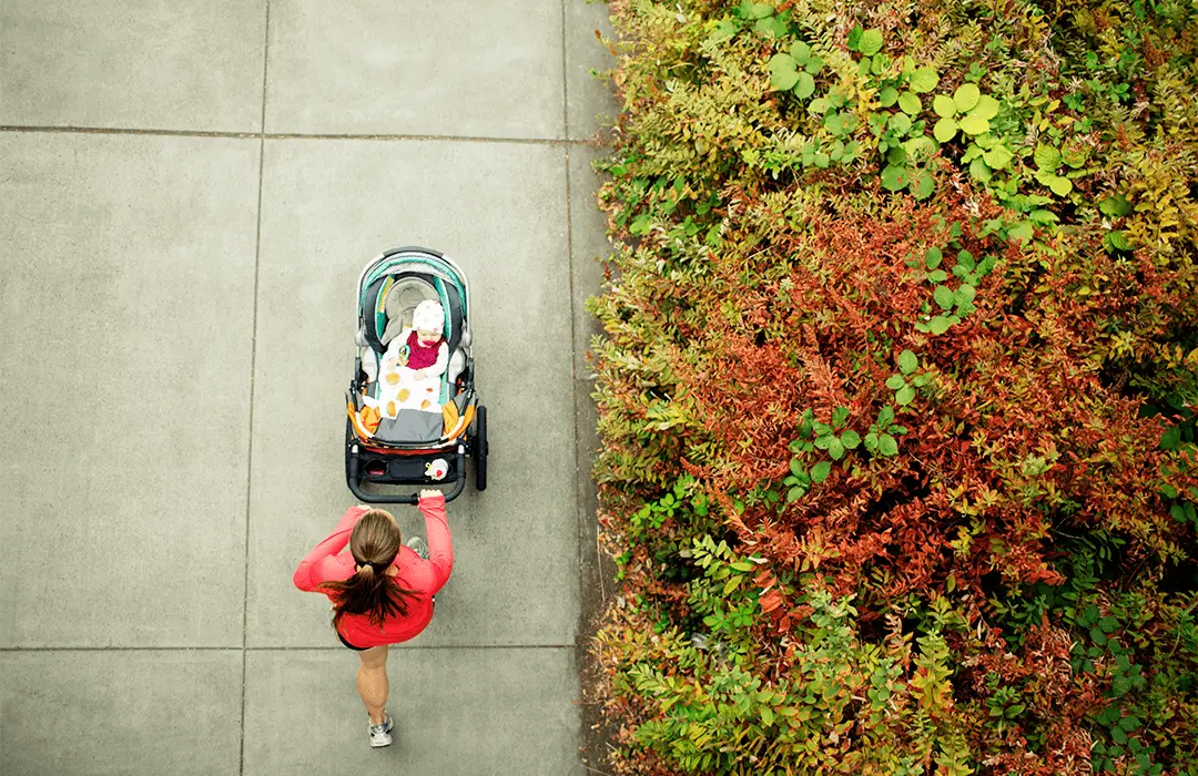 Image: Supplied Woman taking her baby in a stroller on the street