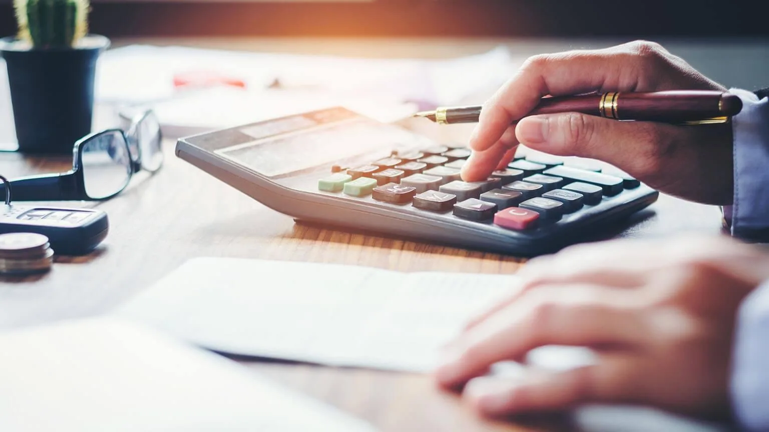 Image: Getty Images Man using a calculator