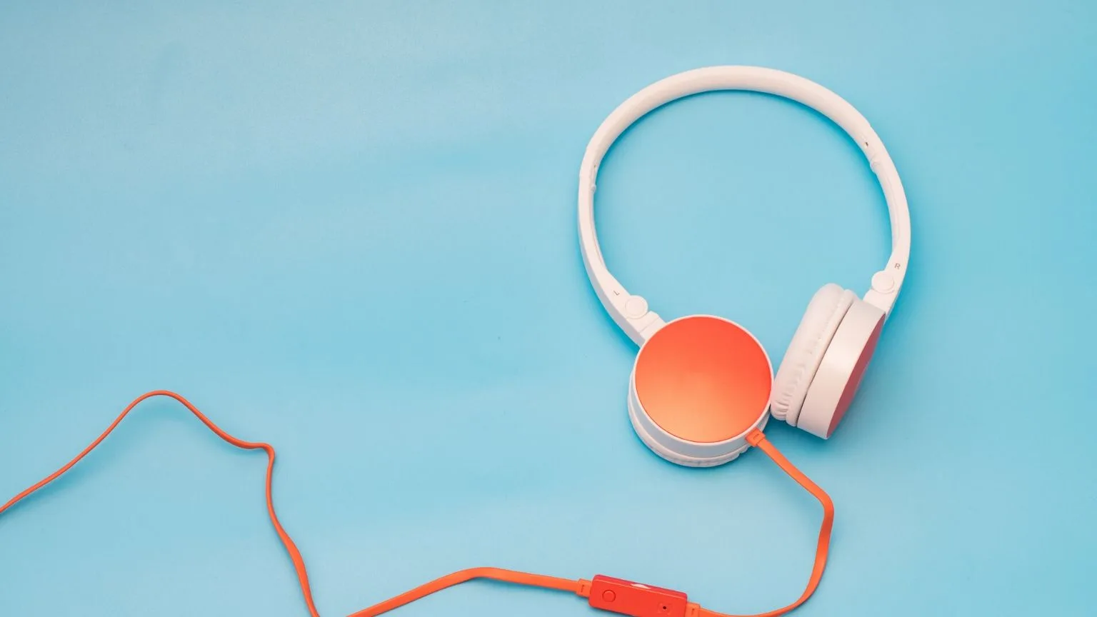 Image: Getty Images White and orange headphones on a blue background