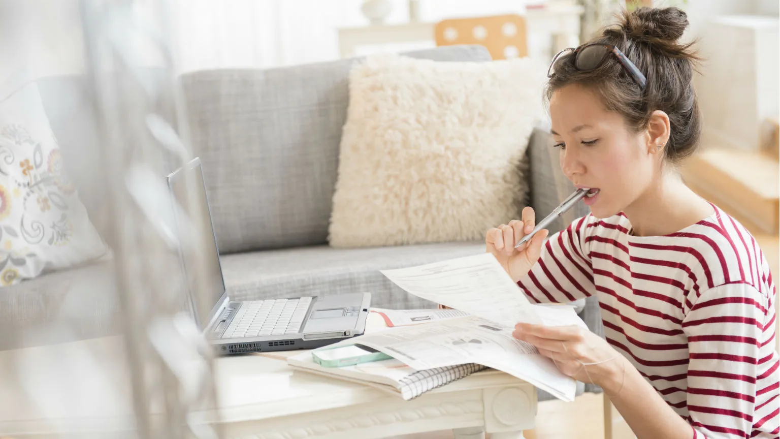 Image: Getty Images Lady reviewing bills.
