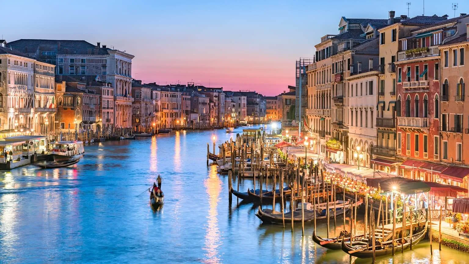Image: Getty Images A gondolier paddles towards the sunset in Venice's Grand Canal