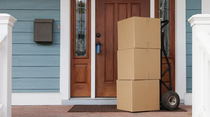 Image: Getty Images Cardboard boxes on front porch of a house