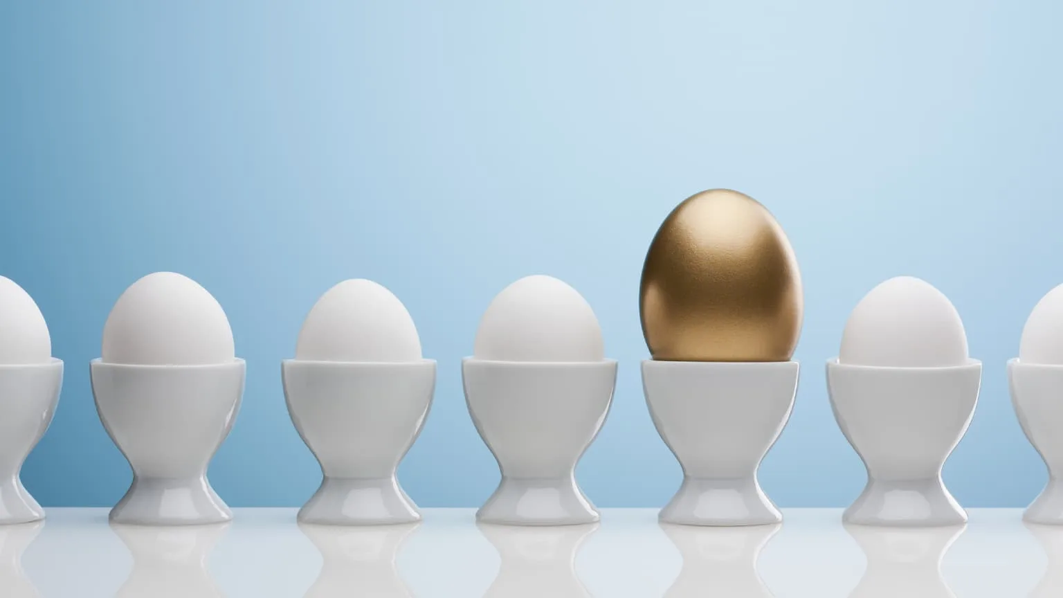 Image: Getty Images Gold egg standing out from white eggs.