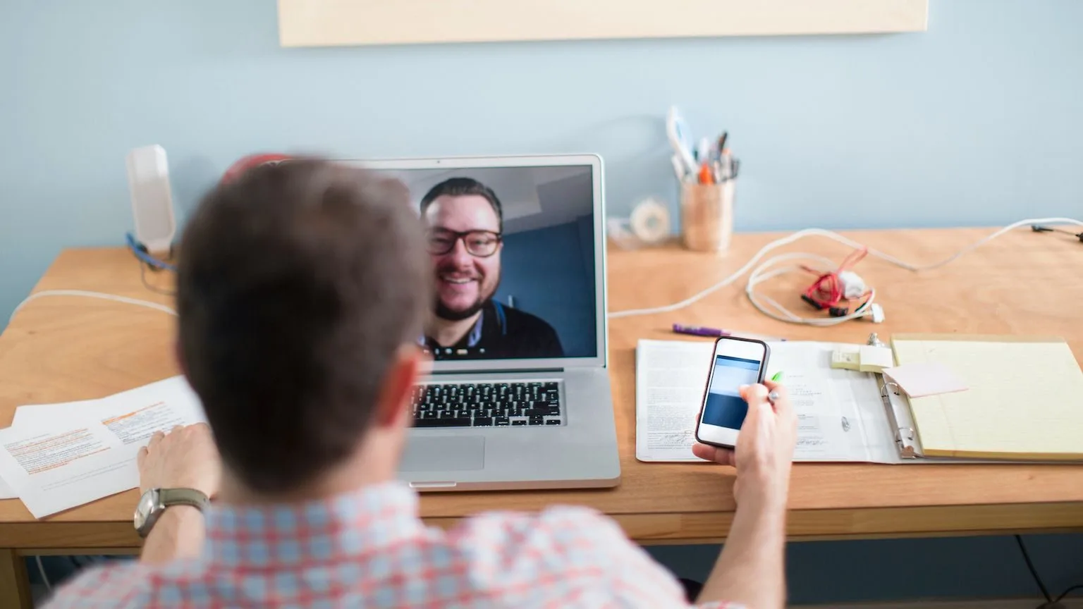 Image: Getty Images Two men having a video conference call.
