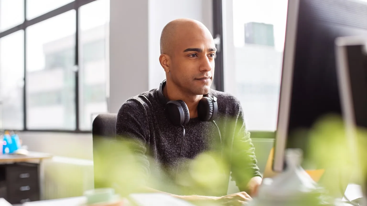 Image: Getty Images Business man working on desktop PC in office