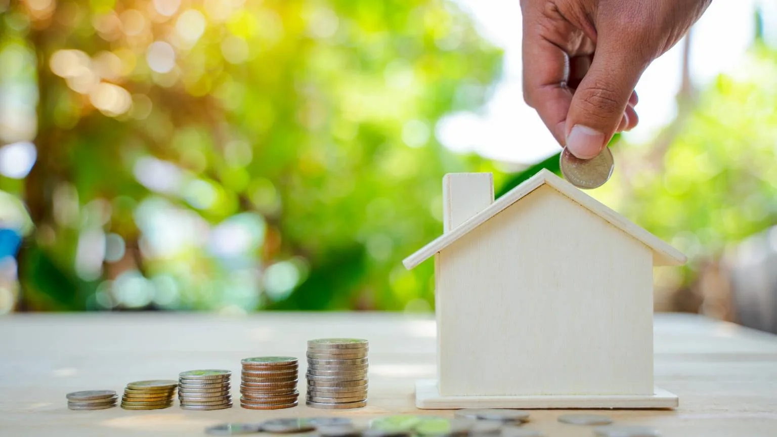 Image: Getty Images House model and coins stacks on wooden table