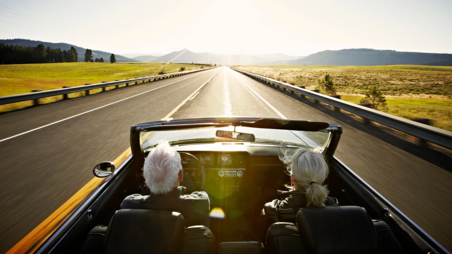 Image: Getty Images two seniors driving in a convertible on an open road