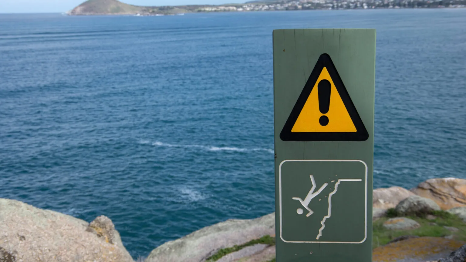 Image: Getty Images Caution sign with a drawing of a person falling of a cliff below