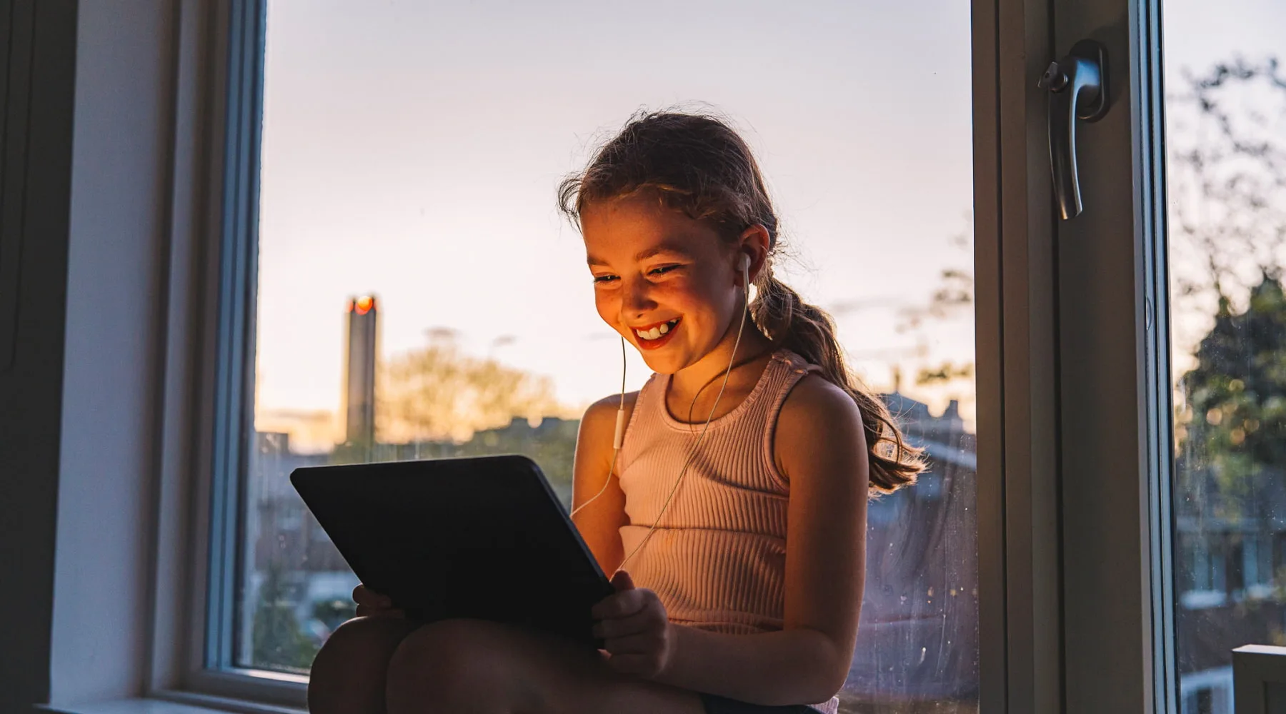GirlLaughsWhileUsingTablet_GettyImages_1800x1000 GirlLaughsWhileUsingTablet_GettyImages_1800x1000
