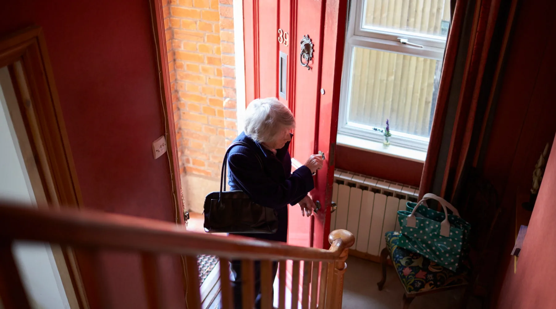 SeniorWomanOpensDoorHome_GettyImages_1800x1000 SeniorWomanOpensDoorHome_GettyImages_1800x1000