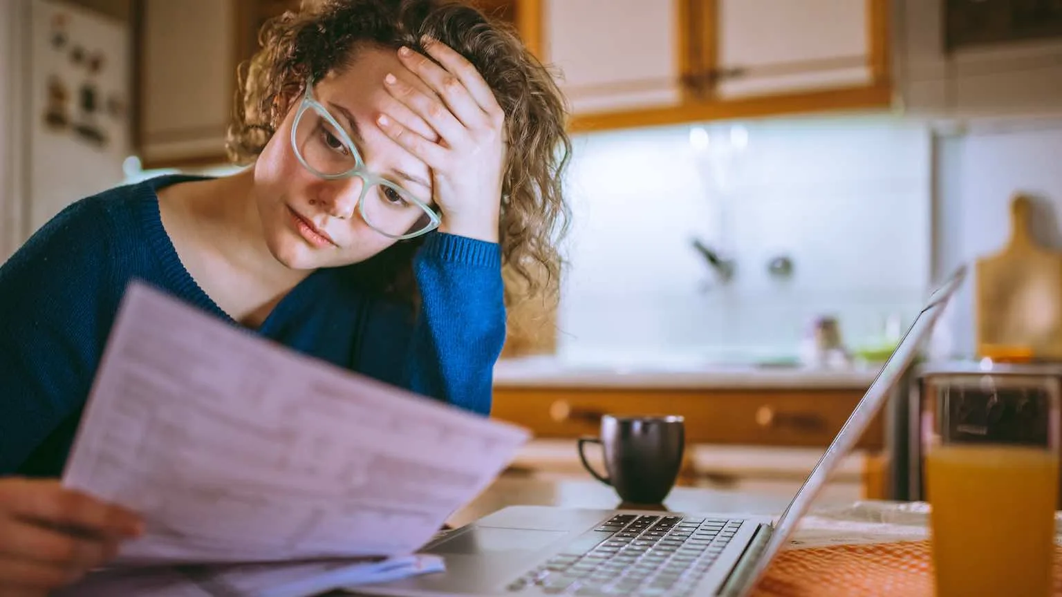 Image: Getty Images Woman paying bills