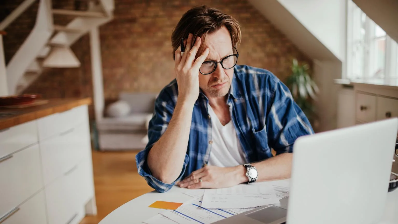 Image: Getty Images Man going through financial paperwork