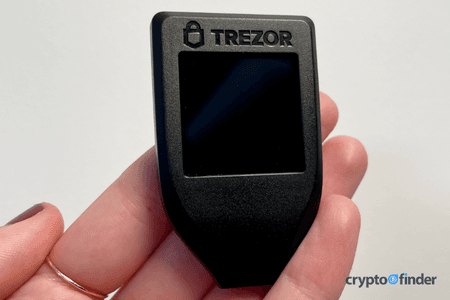 Image: Finder Hand holding a Trezor Model T