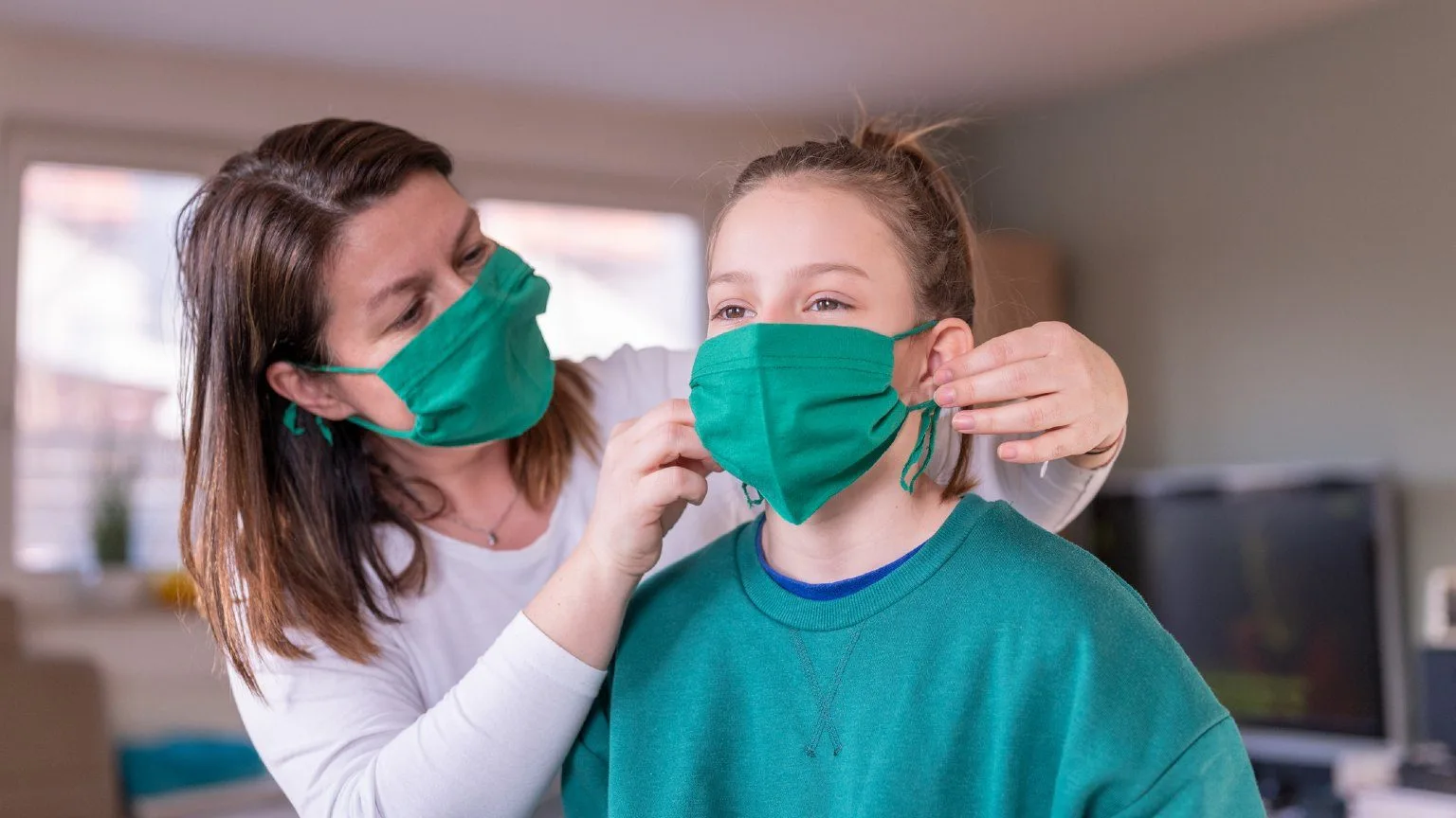 Image: Getty Images Mom and daughter wearing a face mask