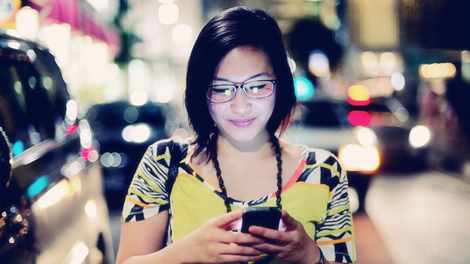 Image: Getty Images woman staring at phone at night