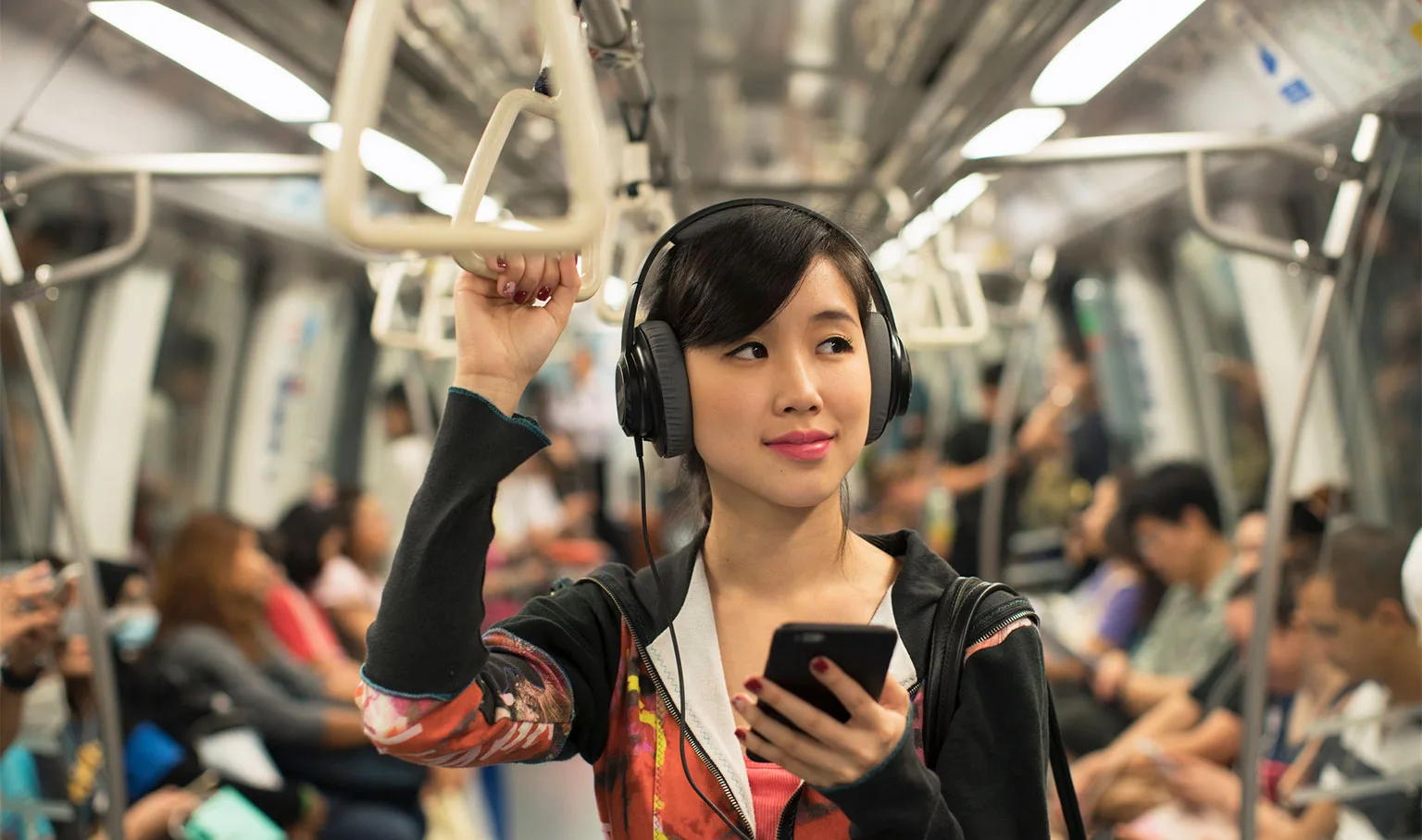 Image: Getty Images woman with phone on train