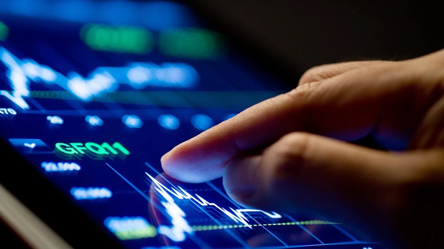 Image: Getty Images Market Analyze with Digital Moniter focus on tip of finger.