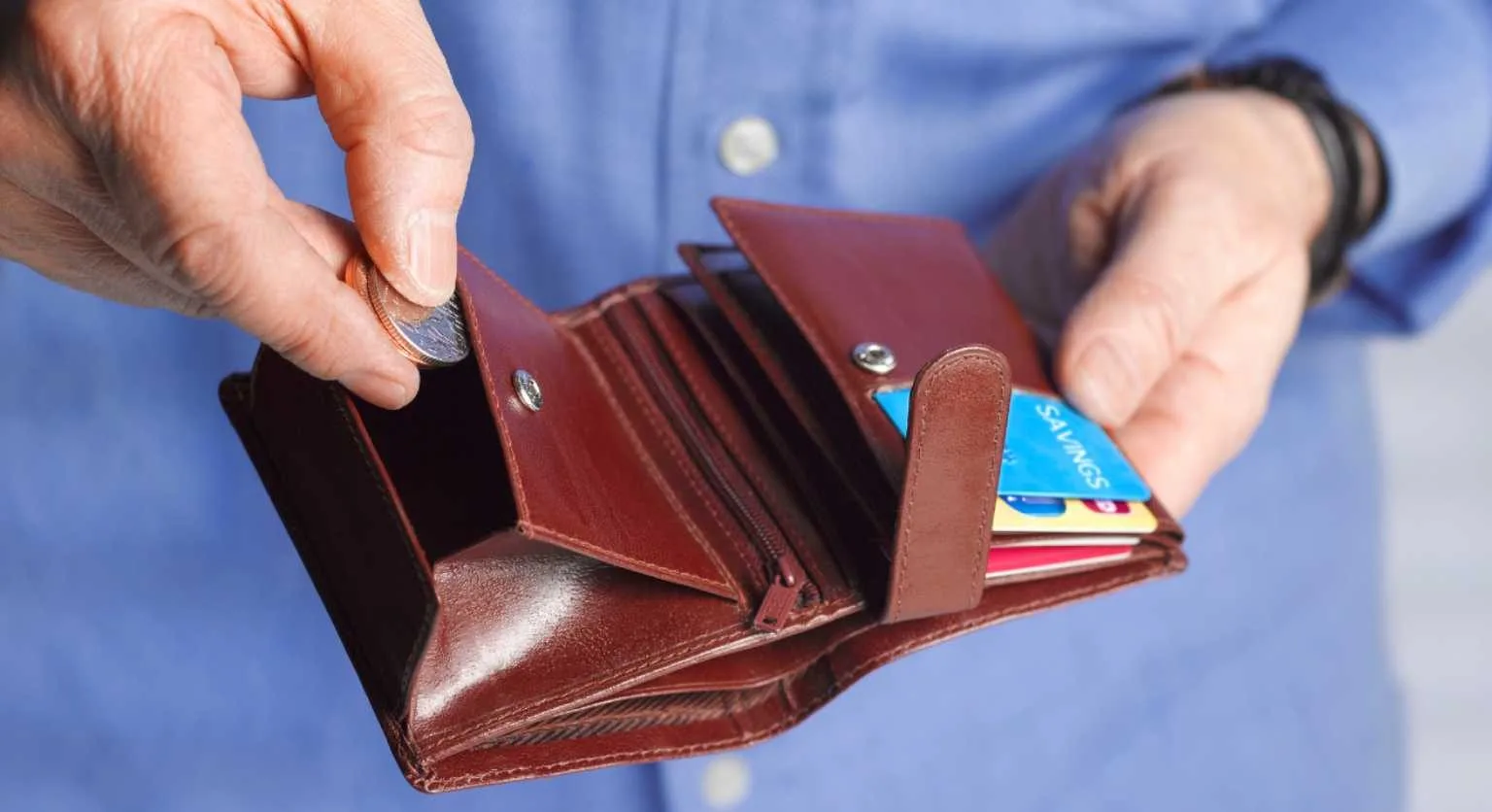 Image: Getty Images Taking coins from a wallet