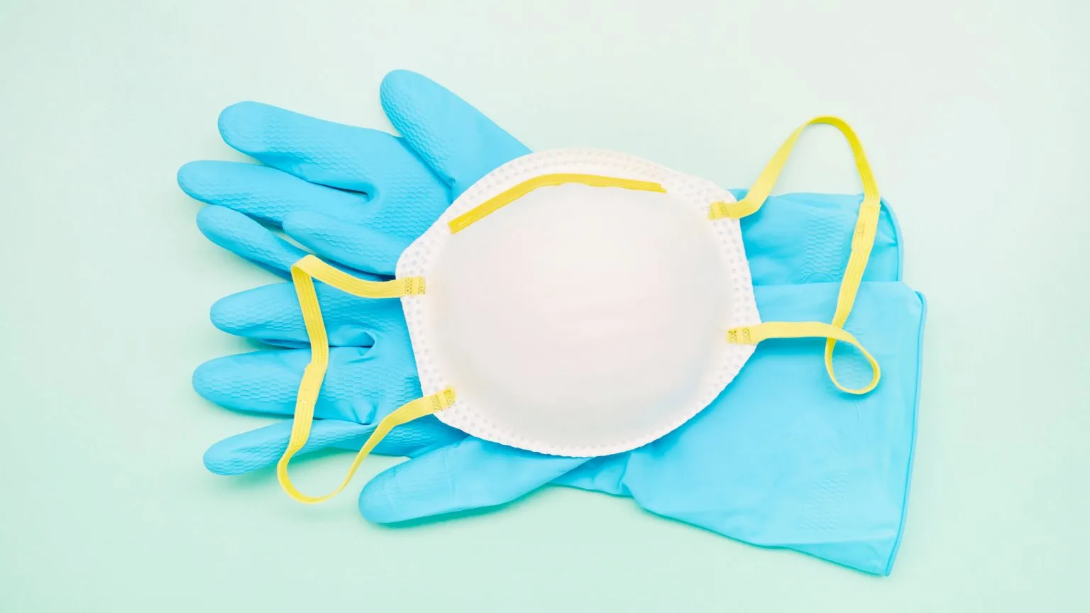 Image: Getty Images Still life of a face mask and blue protective gloves on turquoise background