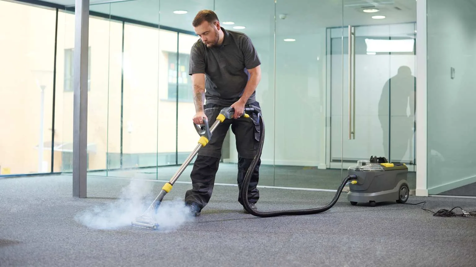 Image: Getty Images a male cleaning contractor steam cleans an office carpet in a empty office in between tenants.