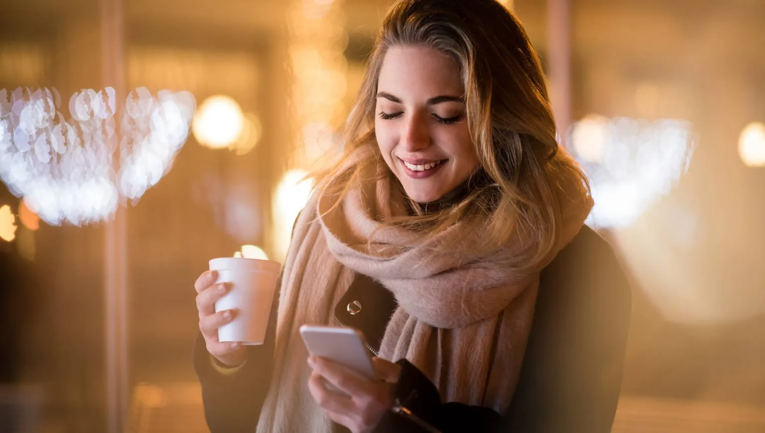 Image: Getty Images Woman holding phone