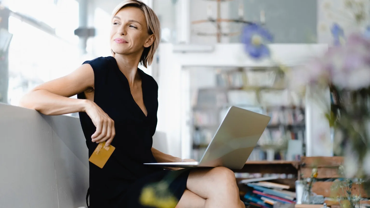 Image: Getty Images Woman with card and laptop