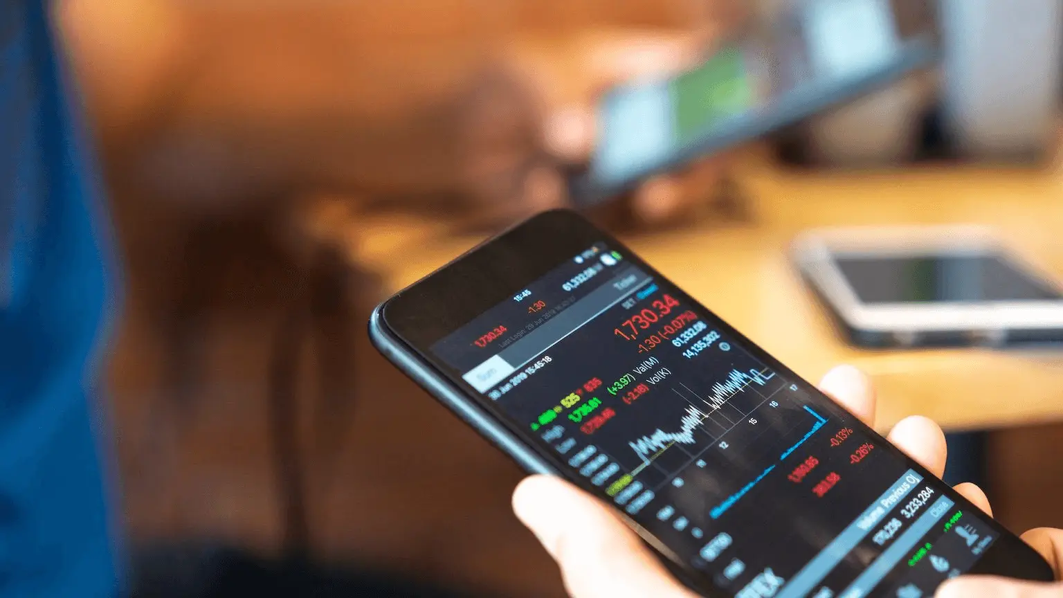 Image: Getty Images using mobile cellphone to buy shares