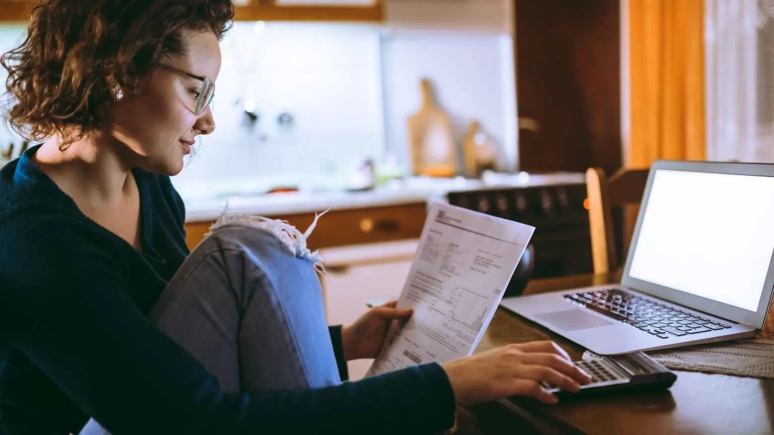Image: Getty Images Woman calculating bills