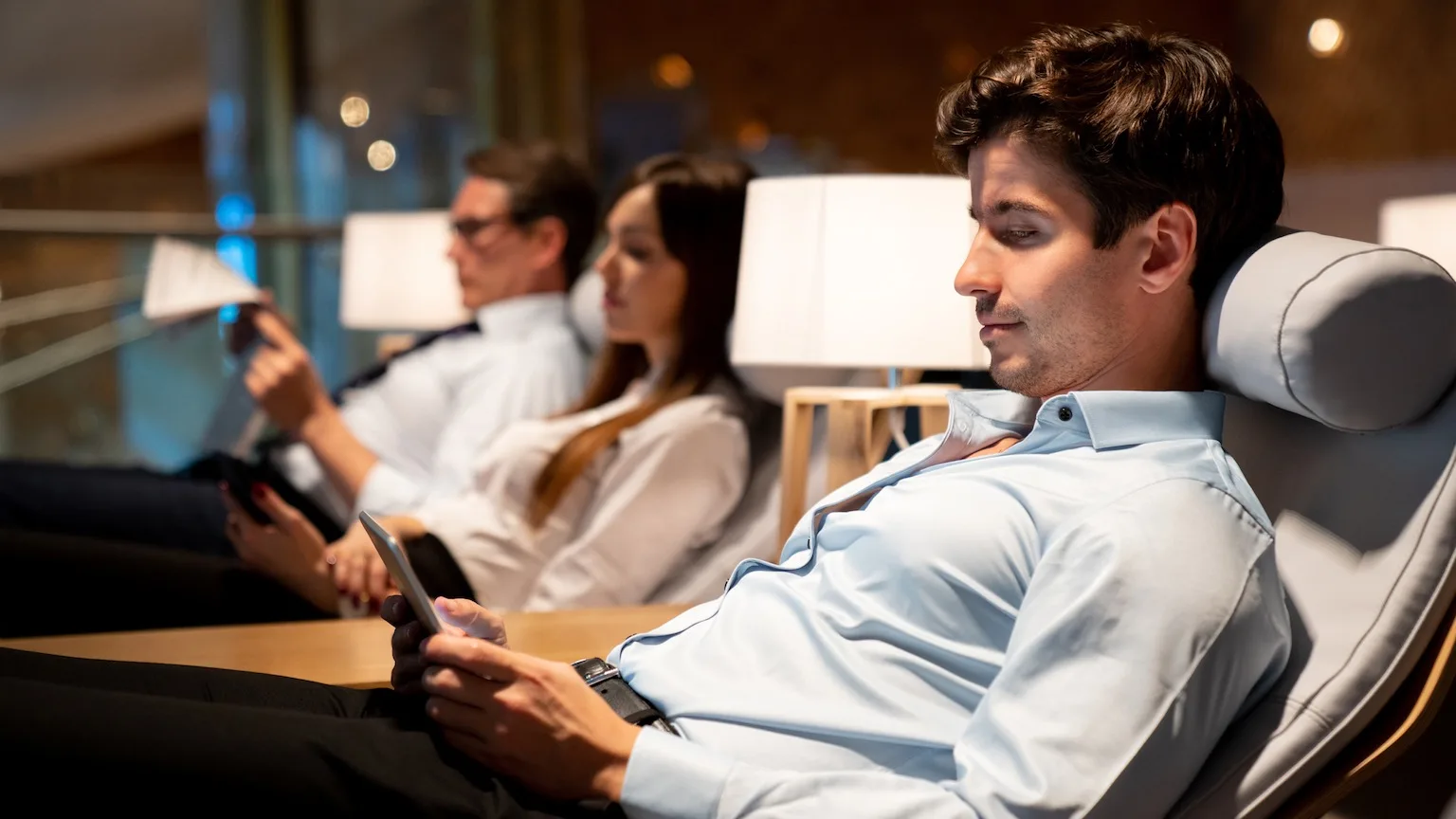 Image: Getty Images Traveling business man relaxing in a VIP lounge at the airport texting on their phone while waiting for his flight - travel concepts (Traveling business man relaxing in a VIP lounge at the airport texting on their phone while waiting for his flight -