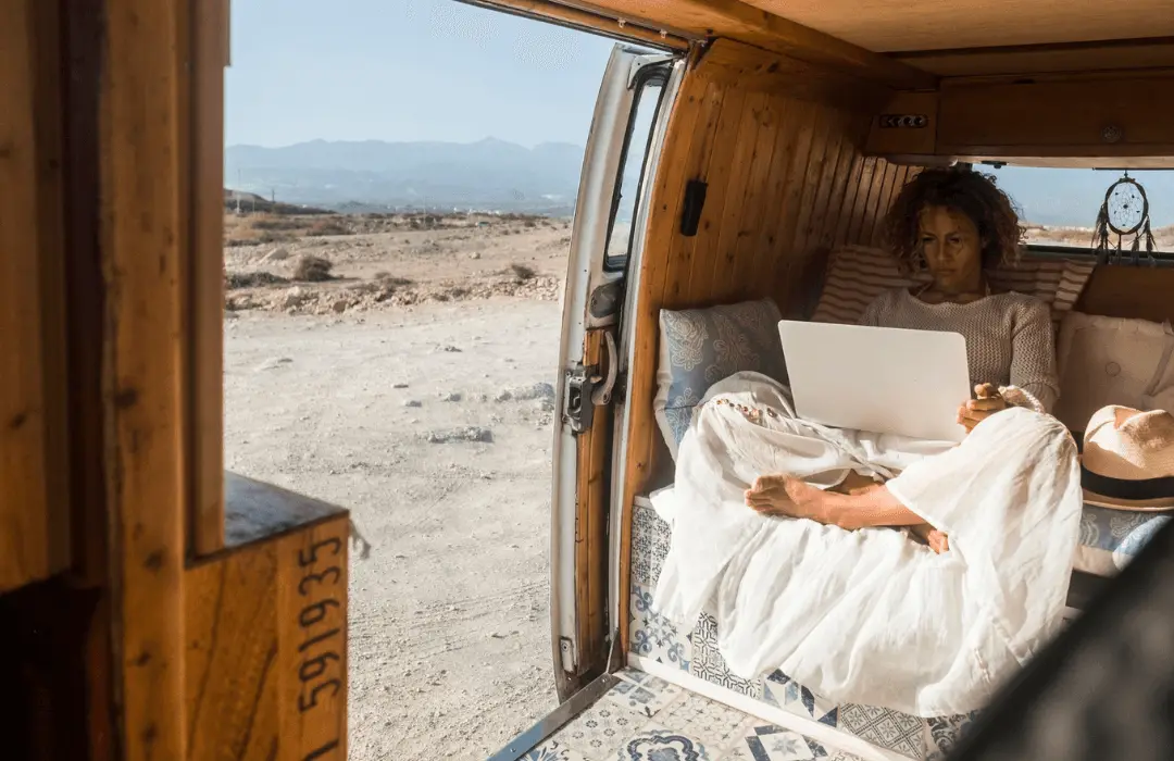 Image: Supplied woman sitting in a van with a laptop on her knees