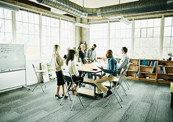 Team of staff having strategy meeting in a studio office