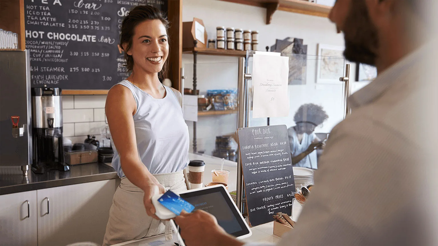 Image: Supplied Man paying at coffeeshop using contactless credit card
