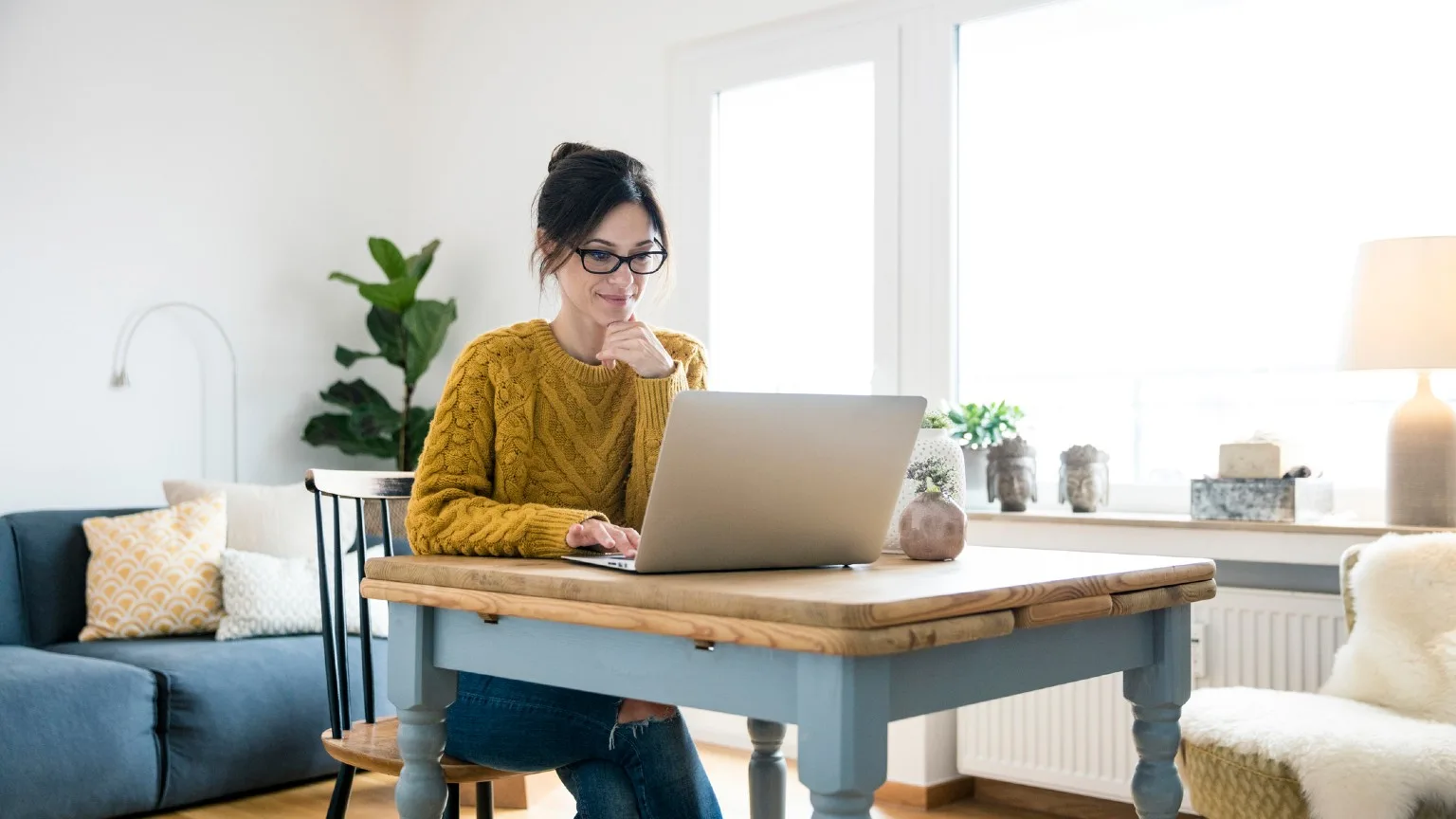Image: Getty Images Woman using laptop at the table