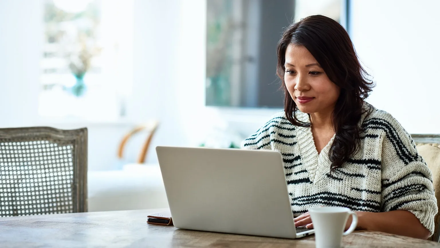 Image: Getty Images Woman on computer at home