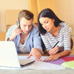 Image: Getty Images young couple on laptop and phone