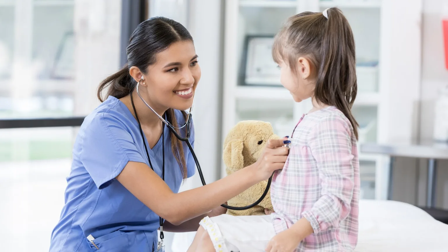 Image: Getty Images Female nurse treating a child
