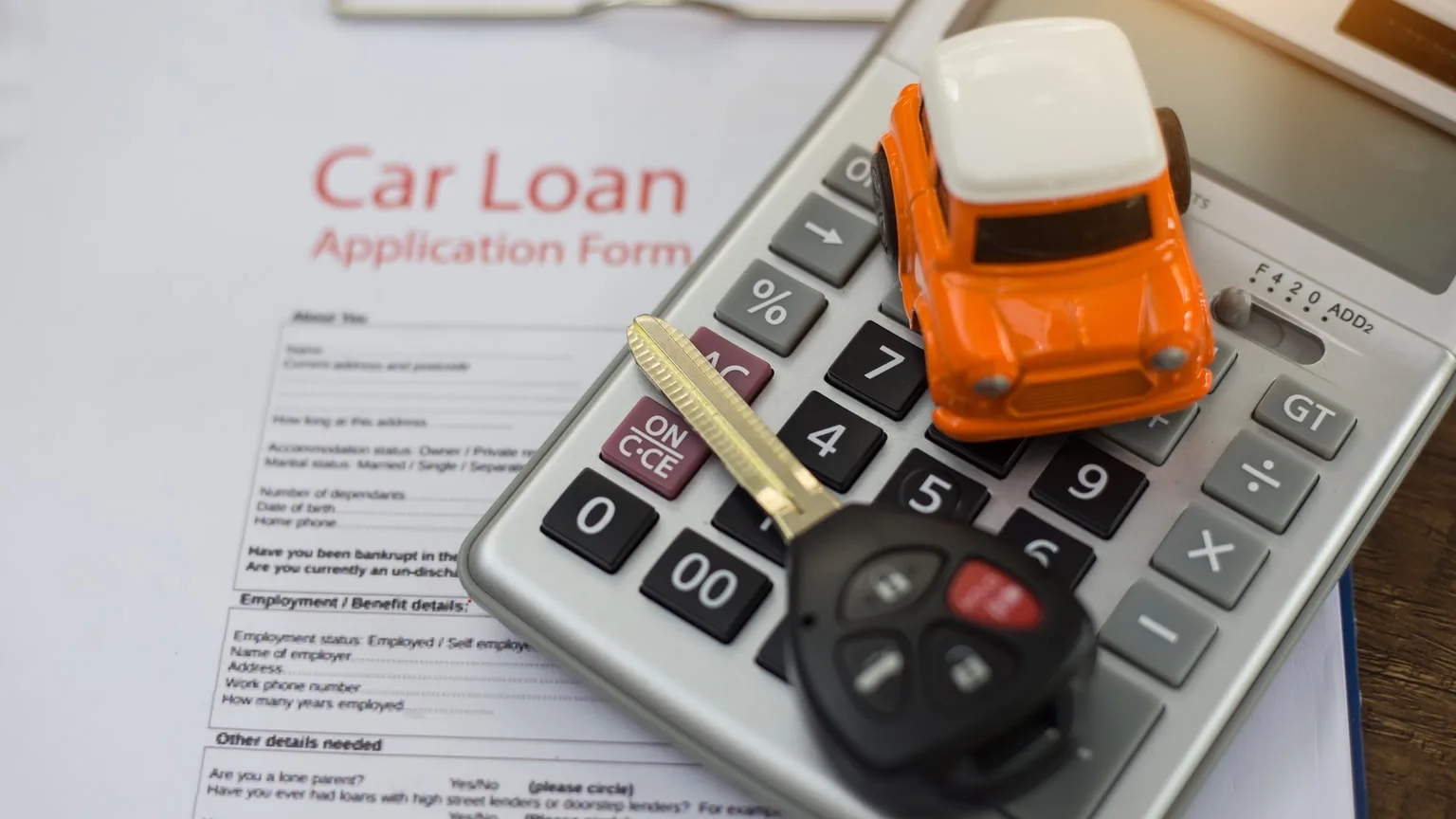 Image: Getty Images Model car, calculator, keys and car loan documents