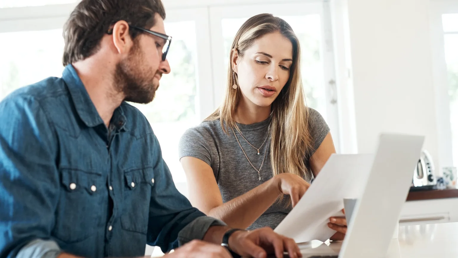Image: Getty Images Couple reviewing loan documents