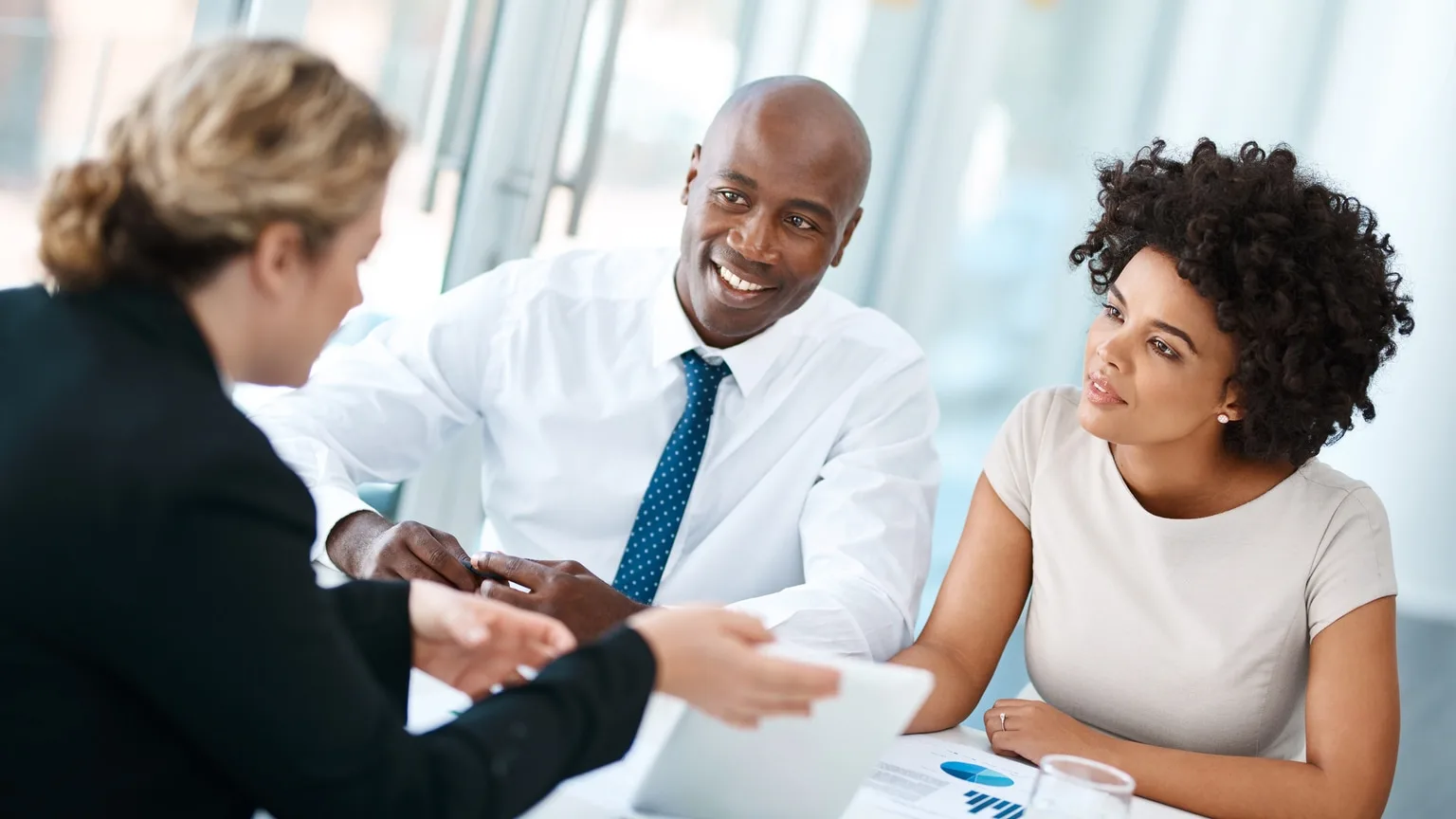 Image: Getty Images Young couple meeting with a financial planner