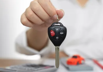 Women holding car keys, car loan concept