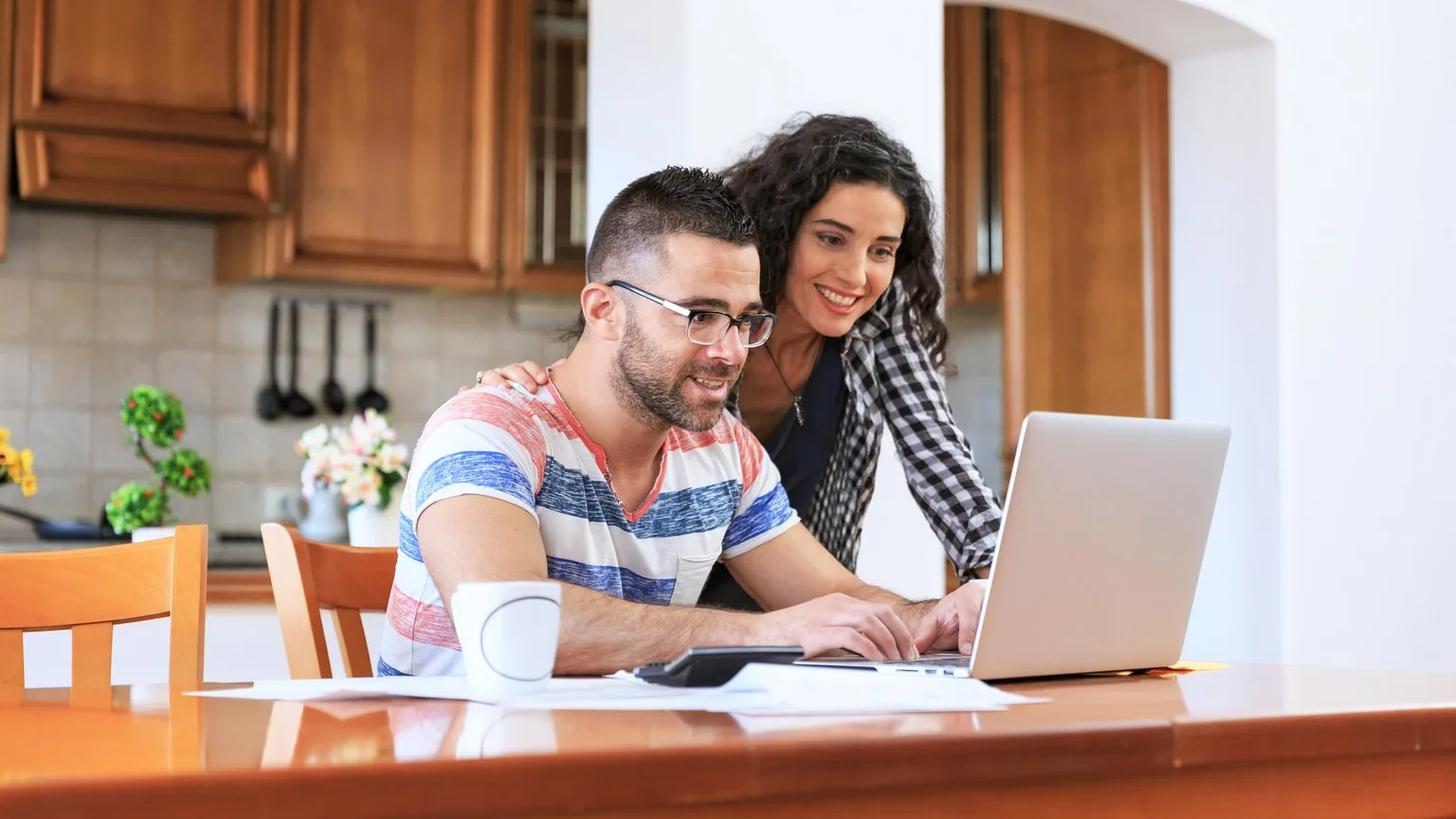 Image: Getty Images Young couple reviewing their financial options online