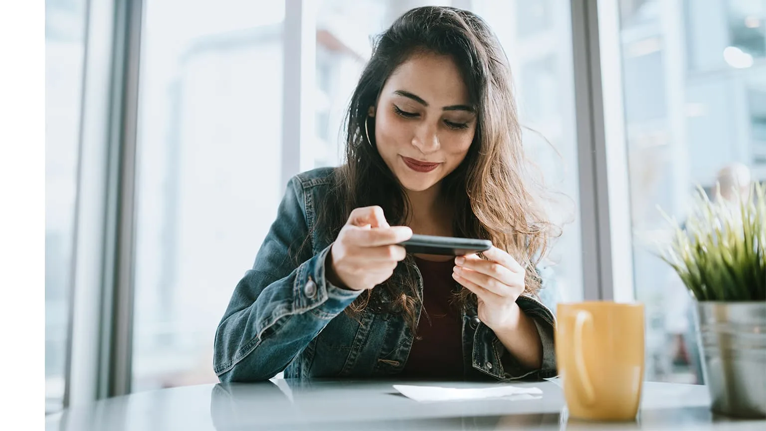 Woman depositing a cheque with her smartphone