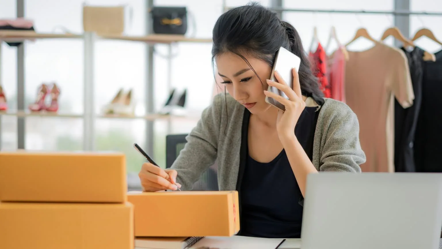 Image: Getty Images Female business owner preparing shipment of orders