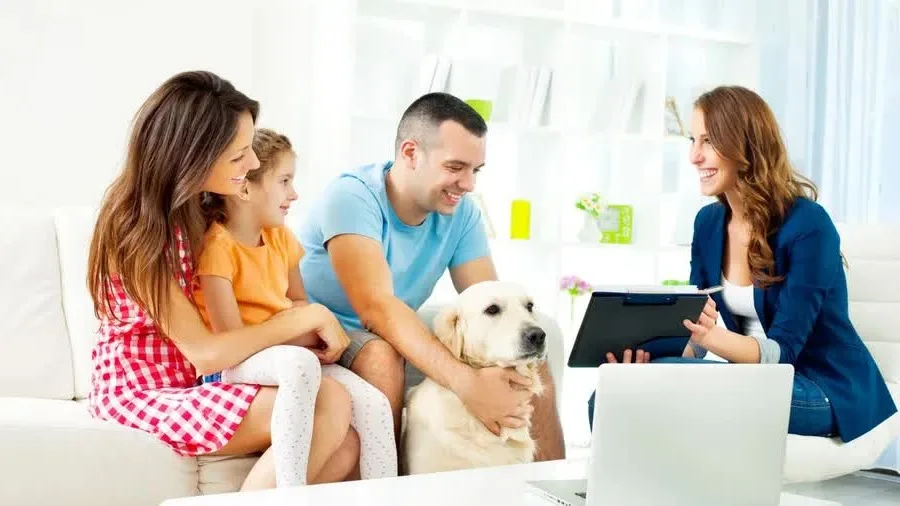 Image: Getty Images Young family reviewing life insurance options